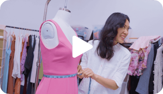 A person standing by a mannequin with pink clothing linking to a seller story