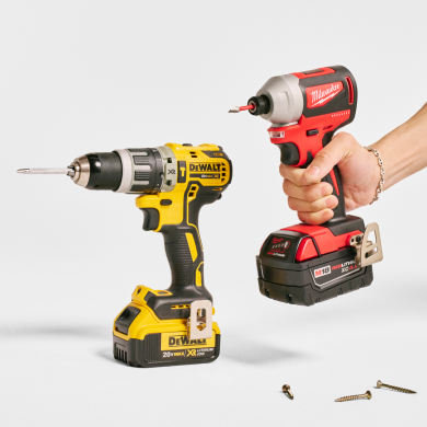 A pair of cordless drills with a hand gripping one of them. Links to Home and Garden page.