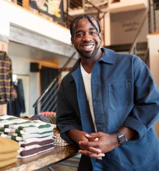 A Black man standing in his store
