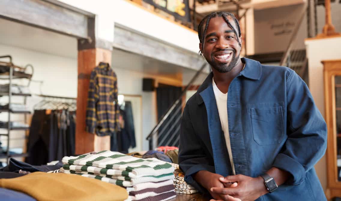 A Black man standing in his store