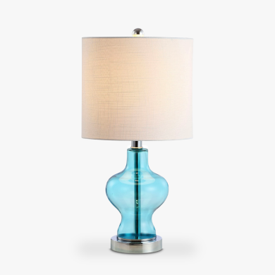 A JONATHAN Y table lamp with a white shade and an aqua blue body.