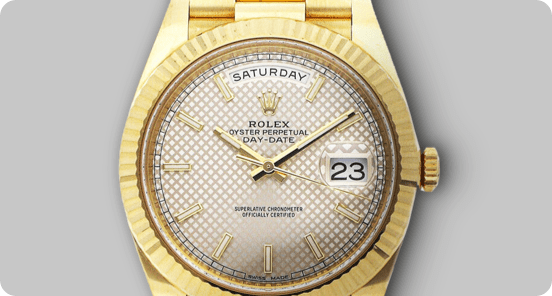 A silver and gold Rolex on a light grey background.