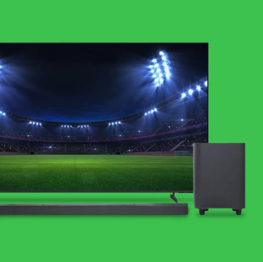 An LG TV, speaker, and soundbar against a green background.