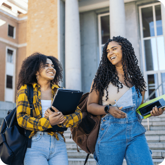 Two people holding notebooks linking to streetwear fashion page.