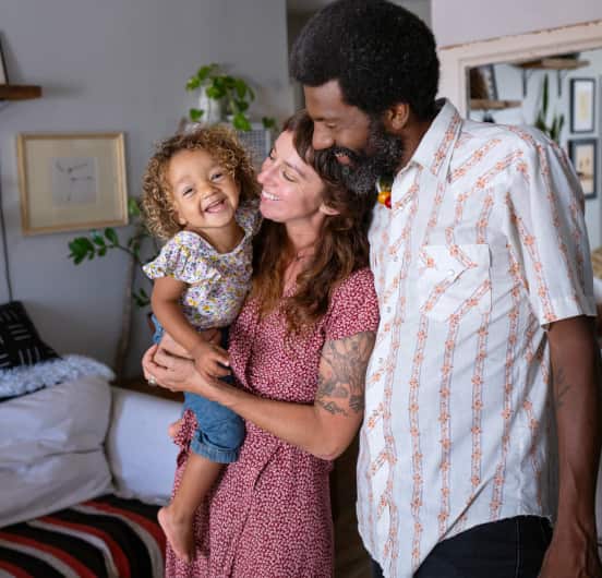 A man and woman holding a child linking to an eBay Inc article