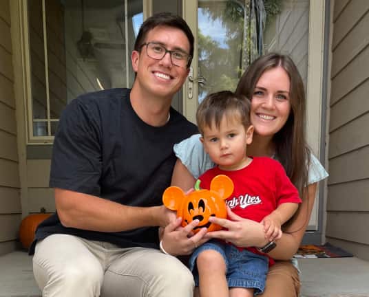 A man, women, and a child holding an orange Mickey Mouse bucket linking to an eBay Inc article