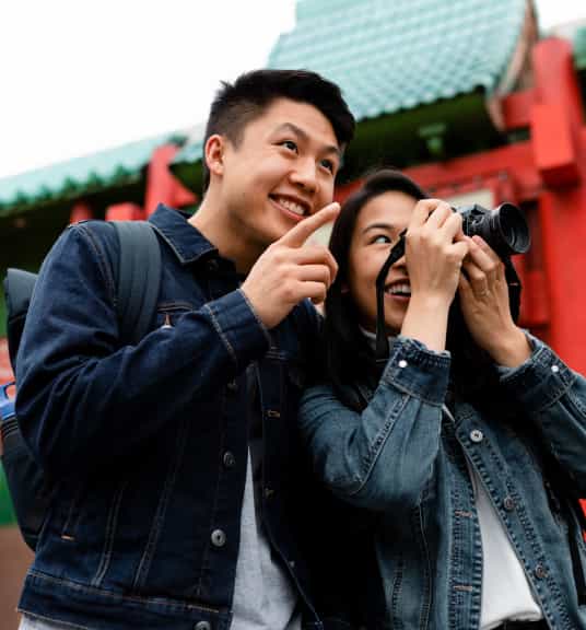 A man pointing and a woman holding a camera linking to eBay Refurbished page