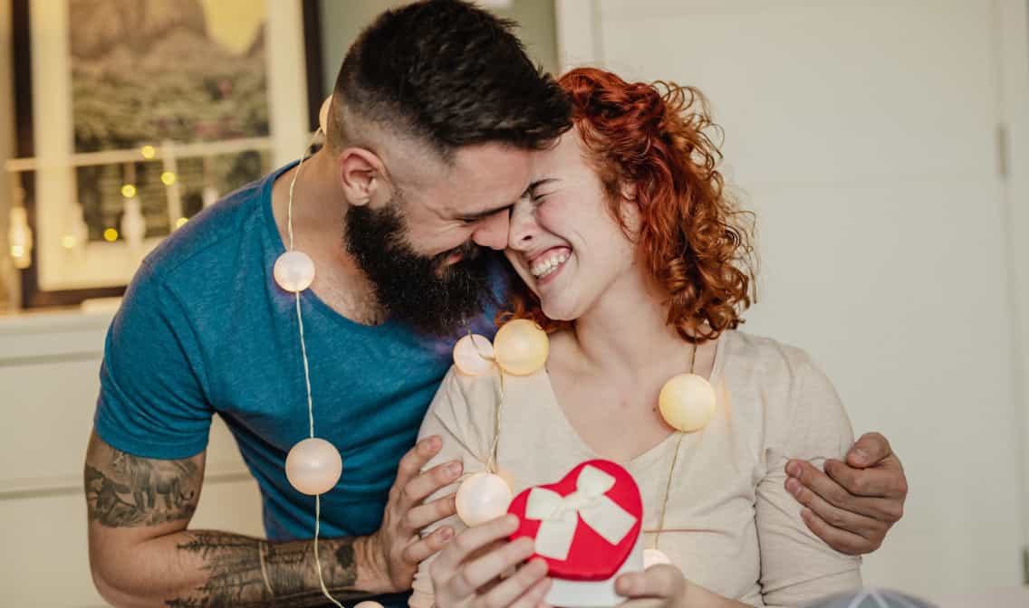 Two people hugging and smiling linking to Valentine's Day gifts page