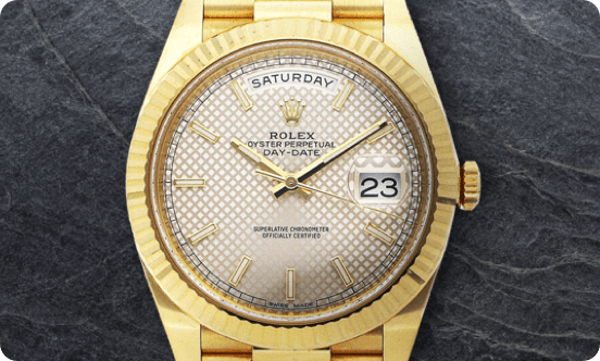 A gold Rolex on a black textured background.